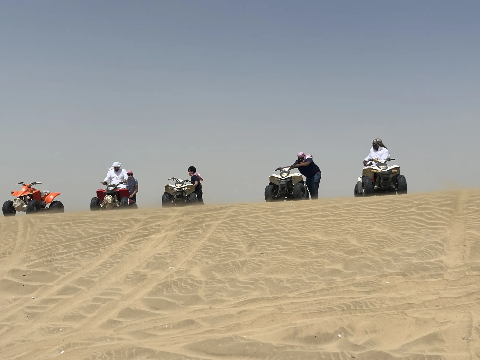 Students riding across open desert sand during a group outing near Jeddah.