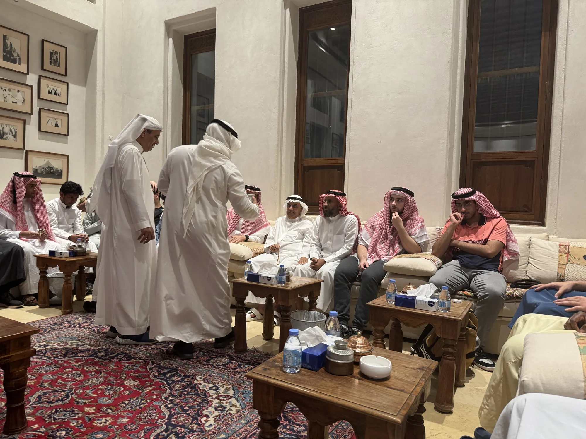Students listening and talking during an intimate evening gathering hosted in Jeddah.
