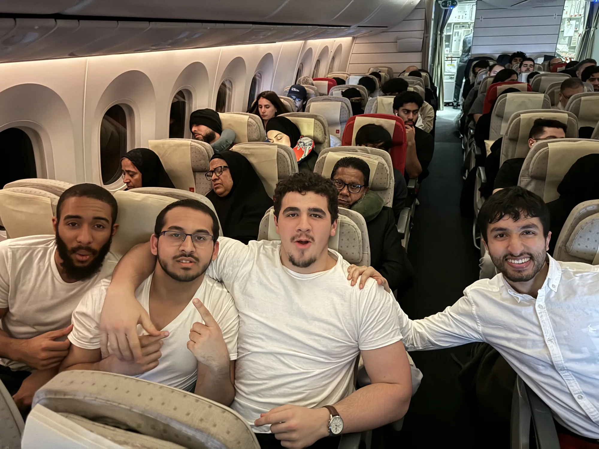 Students seated together on an aircraft during the flight to Saudi Arabia.