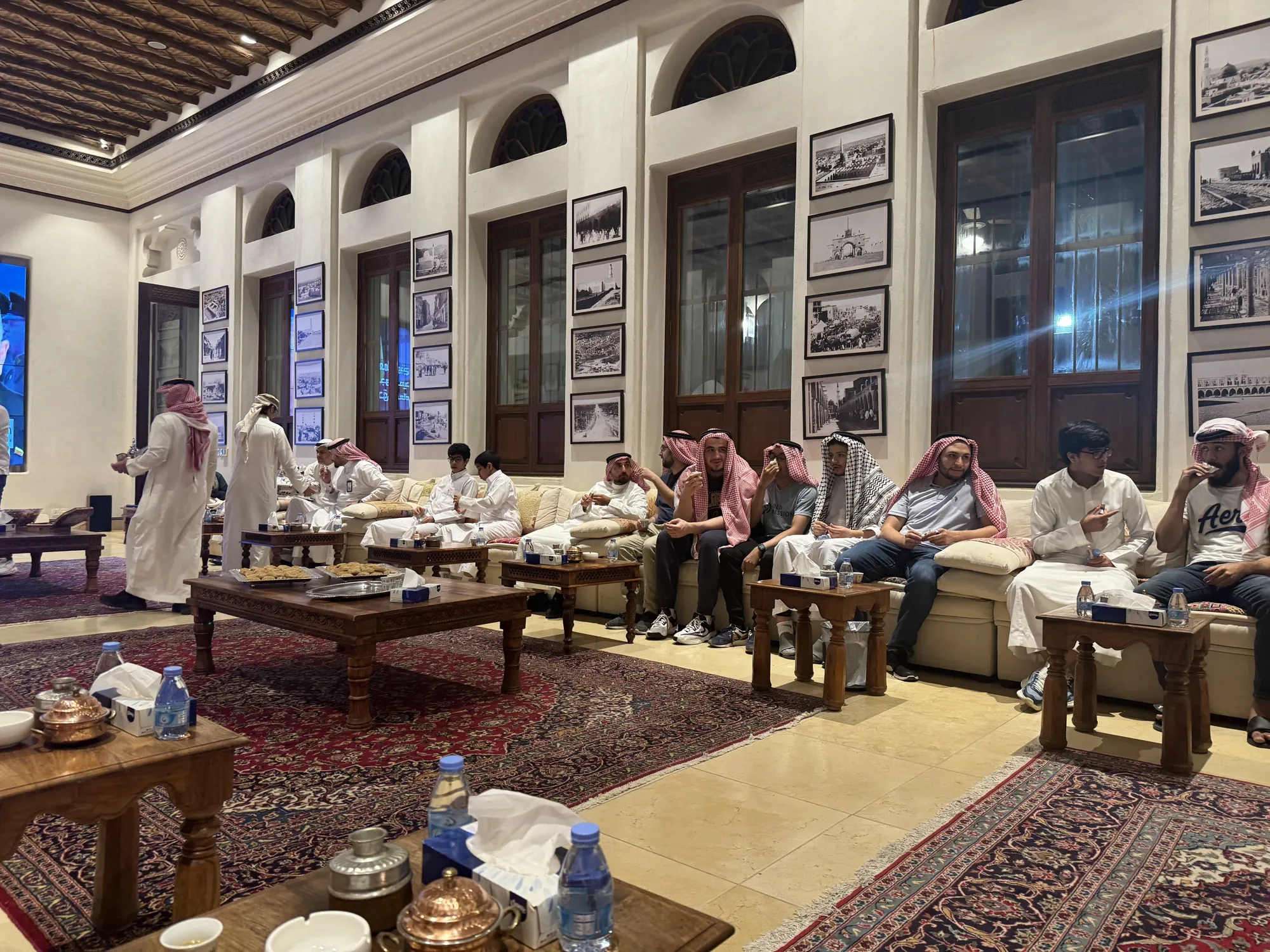 Students seated with local hosts in a majlis for an evening gathering.