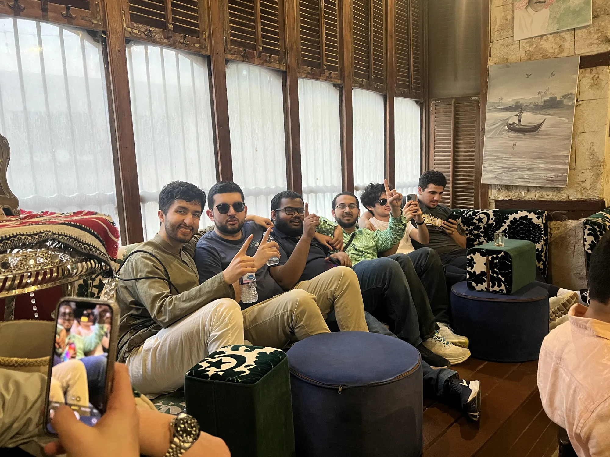 Students sharing tea and conversation at an old tea shop in historic Jeddah.